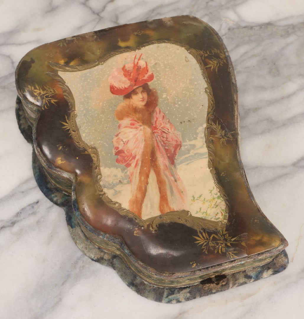 Lot 065 - Antique Victorian Celluloid Dresser Set Box With Woman In Extravagant Pink Coat, Winter Scene On Cover, Note Missing Contents, Various Wear And Tear To Cover