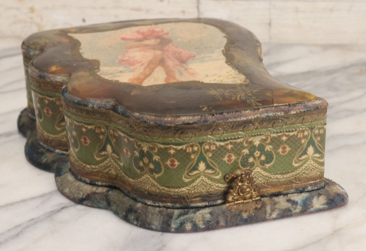 Lot 065 - Antique Victorian Celluloid Dresser Set Box With Woman In Extravagant Pink Coat, Winter Scene On Cover, Note Missing Contents, Various Wear And Tear To Cover