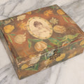 Lot 066 - Antique Victorian Celluloid Dresser Box With Woman In Dress, Floral Pattern On Cover, Tufted Green Interior, Note Cover Separation, Repair Glue Visible