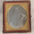 Lot 069 - Antique 1/6th Plate Daguerreotype Photograph Of Young Girl In Plaid Dress With Beaded Handbag Seated Beside A Table With Books In Half Leatherette Case