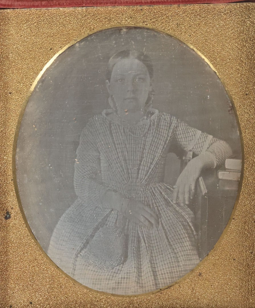 Lot 069 - Antique 1/6th Plate Daguerreotype Photograph Of Young Girl In Plaid Dress With Beaded Handbag Seated Beside A Table With Books In Half Leatherette Case