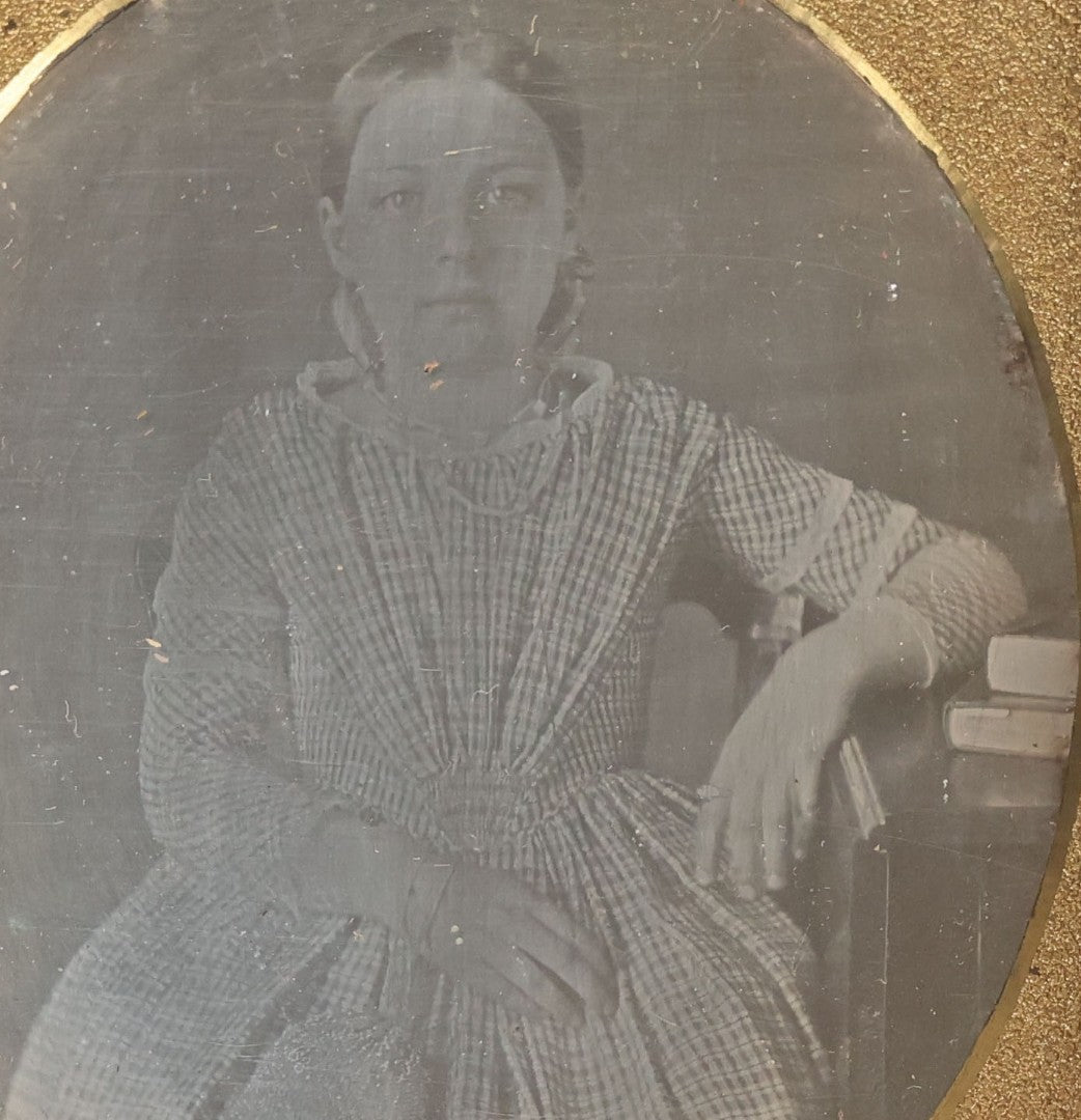 Lot 069 - Antique 1/6th Plate Daguerreotype Photograph Of Young Girl In Plaid Dress With Beaded Handbag Seated Beside A Table With Books In Half Leatherette Case