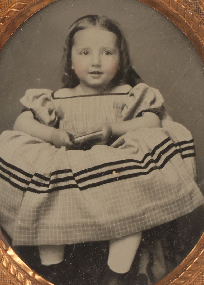 Lot 070 - Antique 1/6th Plate Ruby Ambrotype Photograph Of Smiling Little Girl With Red Tinted Cheeks, Curly Hair, Holding Books, Photograph Taken At Forbes New Gallery, Westfield, Massachusetts, In Half Leatherette Case