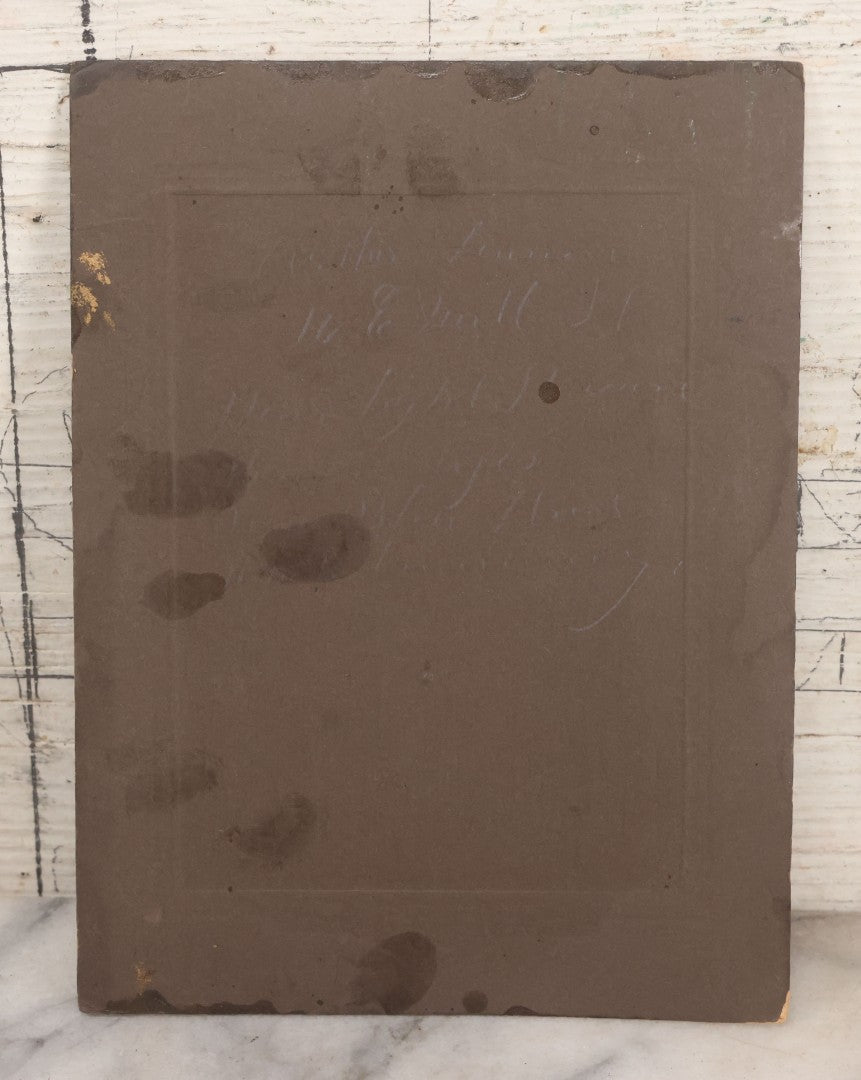 Lot 077 - Antique Boarded Tinted Photograph Of Young Girl In Blue Dress Standing Besides Wicker Chair With Her Period China Doll, Note Color Tinting Notes On Verso