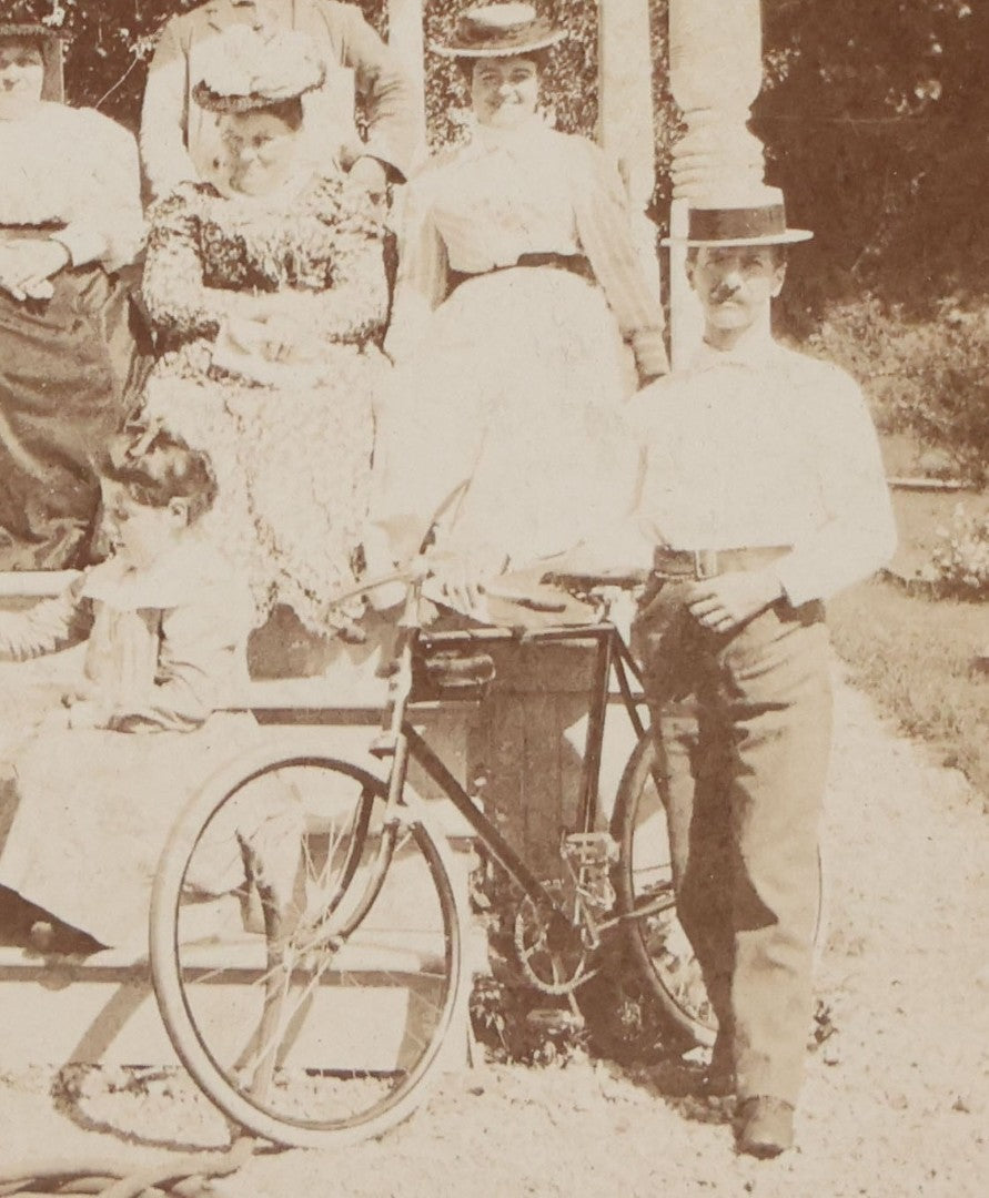 Lot 082 - Antique Boarded Photograph Of Group Of Men Women And Children Standing On Stoop Of Home With Dog And Bicycle