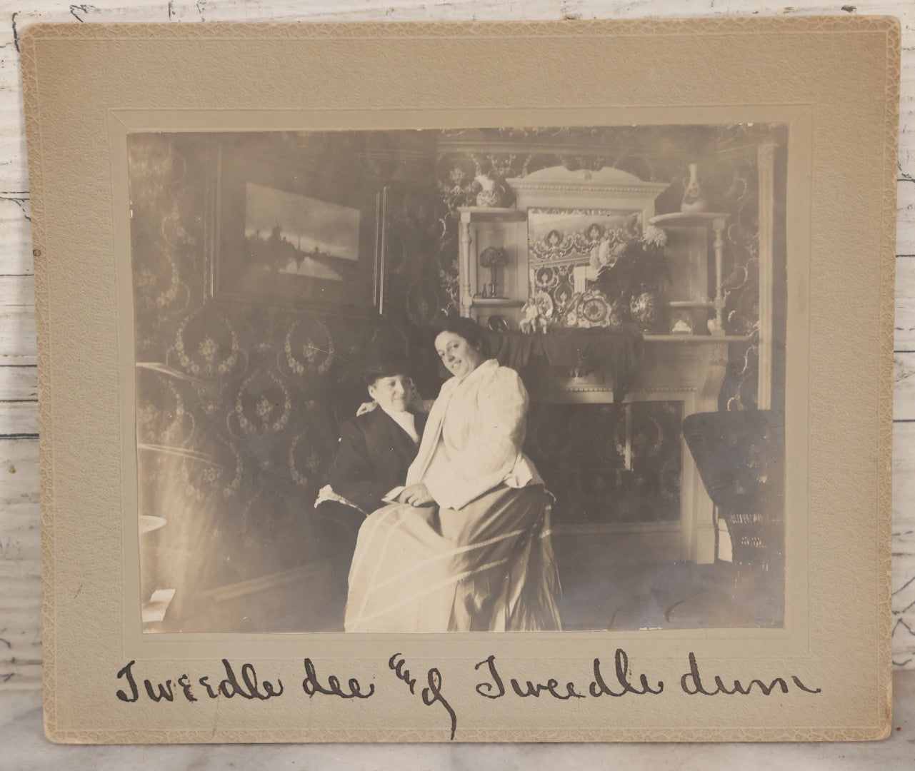 Lot 085 - Antique Boarded Interior Photograph Of Two Women, One Dressed In Suit And Top Hat, With Handwritten Caption "Tweedle Dee And Tweedle Dum"