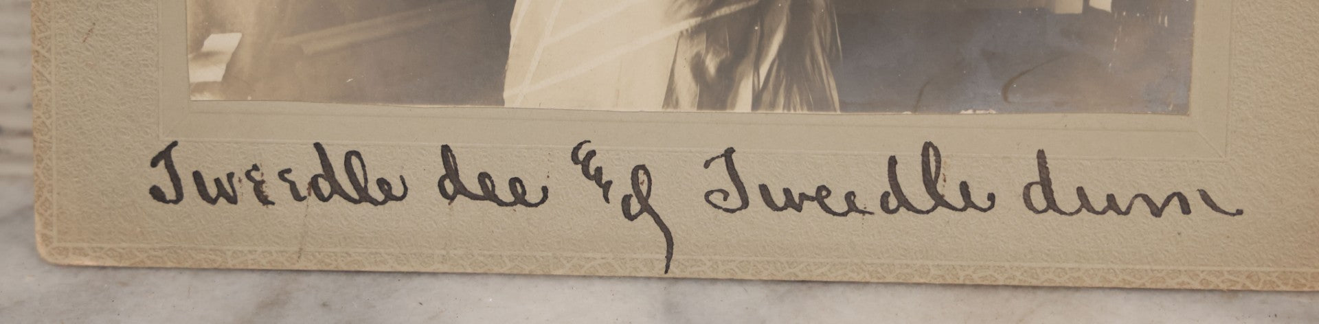 Lot 085 - Antique Boarded Interior Photograph Of Two Women, One Dressed In Suit And Top Hat, With Handwritten Caption "Tweedle Dee And Tweedle Dum"