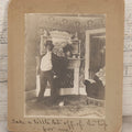 Lot 086 - Antique Boarded Interior Photograph Of Woman Dressed In Suit And Top Hat Smoking Cigar, With Handwritten Caption "Take A Little Bit Off The Top For Me" With Little Dog Figurine