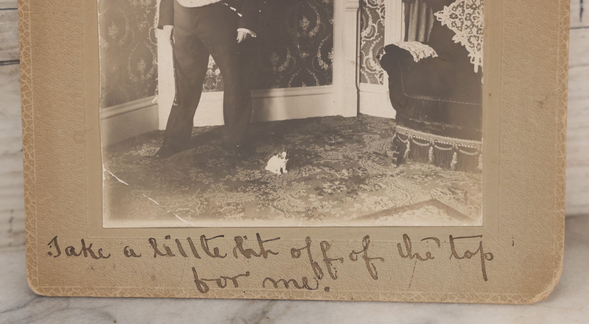 Lot 086 - Antique Boarded Interior Photograph Of Woman Dressed In Suit And Top Hat Smoking Cigar, With Handwritten Caption "Take A Little Bit Off The Top For Me" With Little Dog Figurine