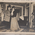 Lot 087 - Antique Boarded Interior Photograph Of Two Women, One Dressed In Suit And Top Hat, Dancing In Parlor
