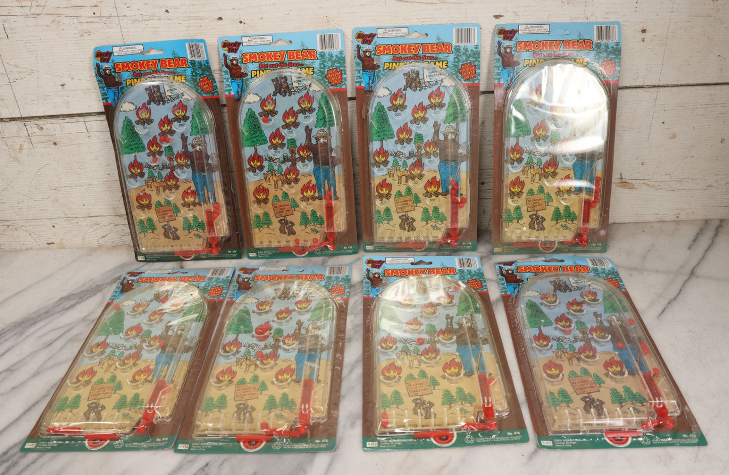Lot 089 - Grouping Of Eight New Old Stock N.O.S. Smokey Bear "Put Out The Fires..." Pinball Game, Manufactured By Gordy International, Inc., Plainfield, New Jersey, No. 476, Made In China
