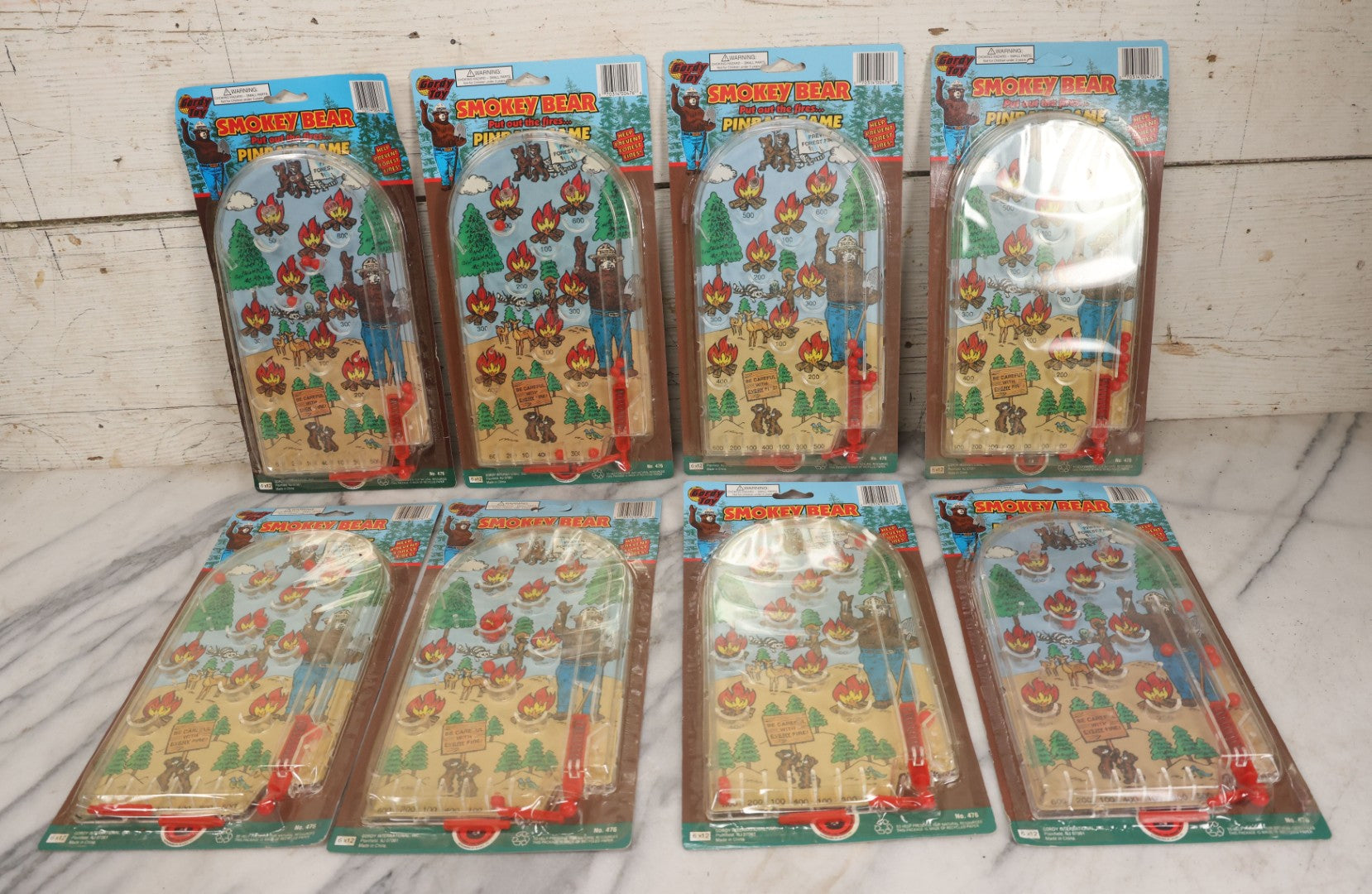 Lot 089 - Grouping Of Eight New Old Stock N.O.S. Smokey Bear "Put Out The Fires..." Pinball Game, Manufactured By Gordy International, Inc., Plainfield, New Jersey, No. 476, Made In China