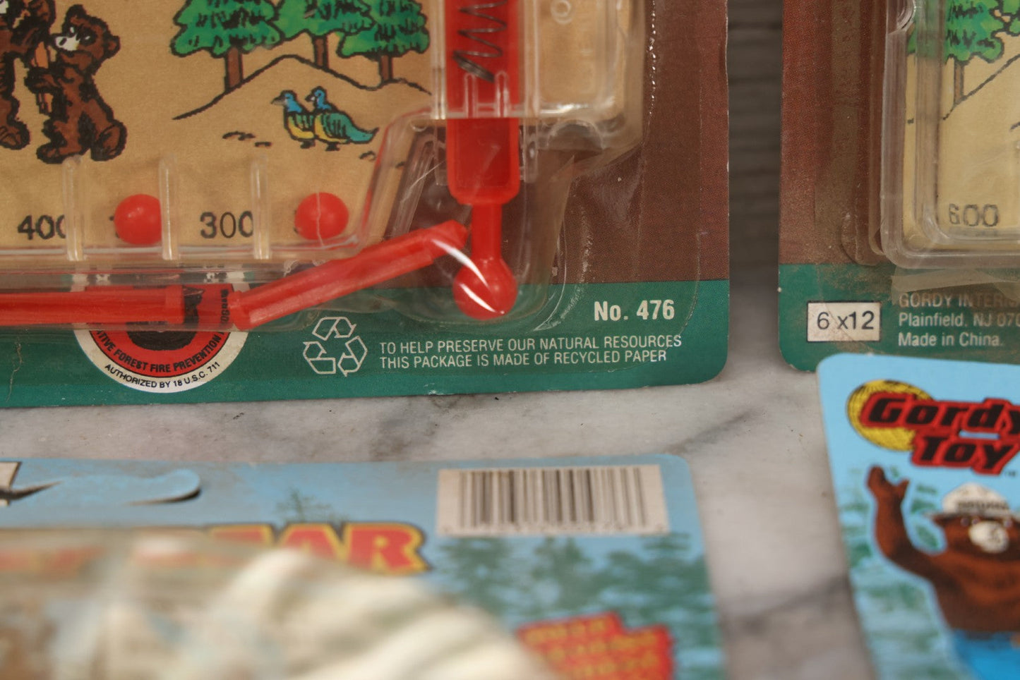 Lot 089 - Grouping Of Eight New Old Stock N.O.S. Smokey Bear "Put Out The Fires..." Pinball Game, Manufactured By Gordy International, Inc., Plainfield, New Jersey, No. 476, Made In China