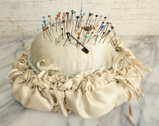 Lot 104 - Vintage Large Size Pincushion With White Silk And Dozens Of Antique With Dozens Of Glass Ball Head Sewing Pins, As Found
