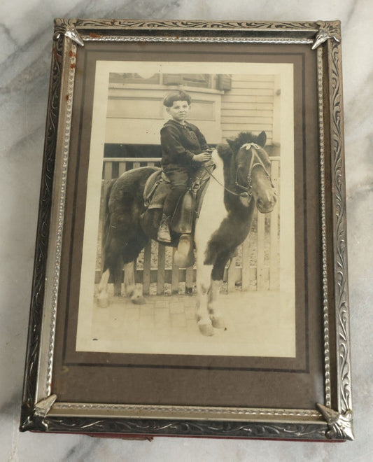 Lot 109 - Vintage Boarded Photograph Of Young Boy With Bowl Cut Riding A Brown And White Pony In Vintage Frame, 5-1/8" x 7-1/8"