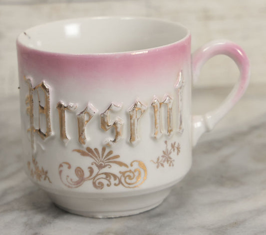 Lot 131 - Antique Porcelain Mug With Pink And Gold "Present" Decoration, Bottom Marked Made In Germany