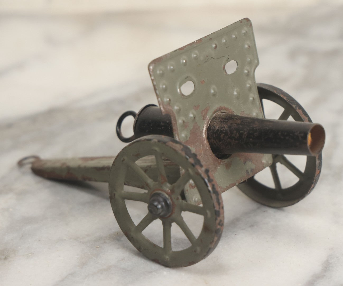 Lot 135 - Vintage Green And Black Painted Tin Toy Cannon With Wheels 