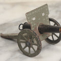 Lot 135 - Vintage Green And Black Painted Tin Toy Cannon With Wheels