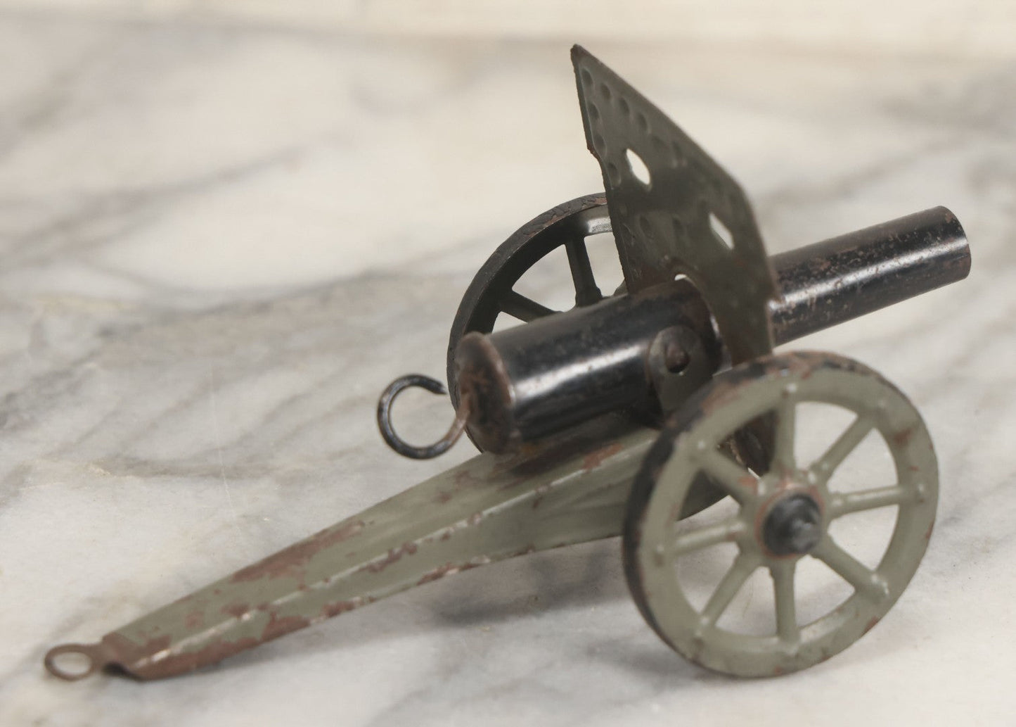 Lot 135 - Vintage Green And Black Painted Tin Toy Cannon With Wheels 