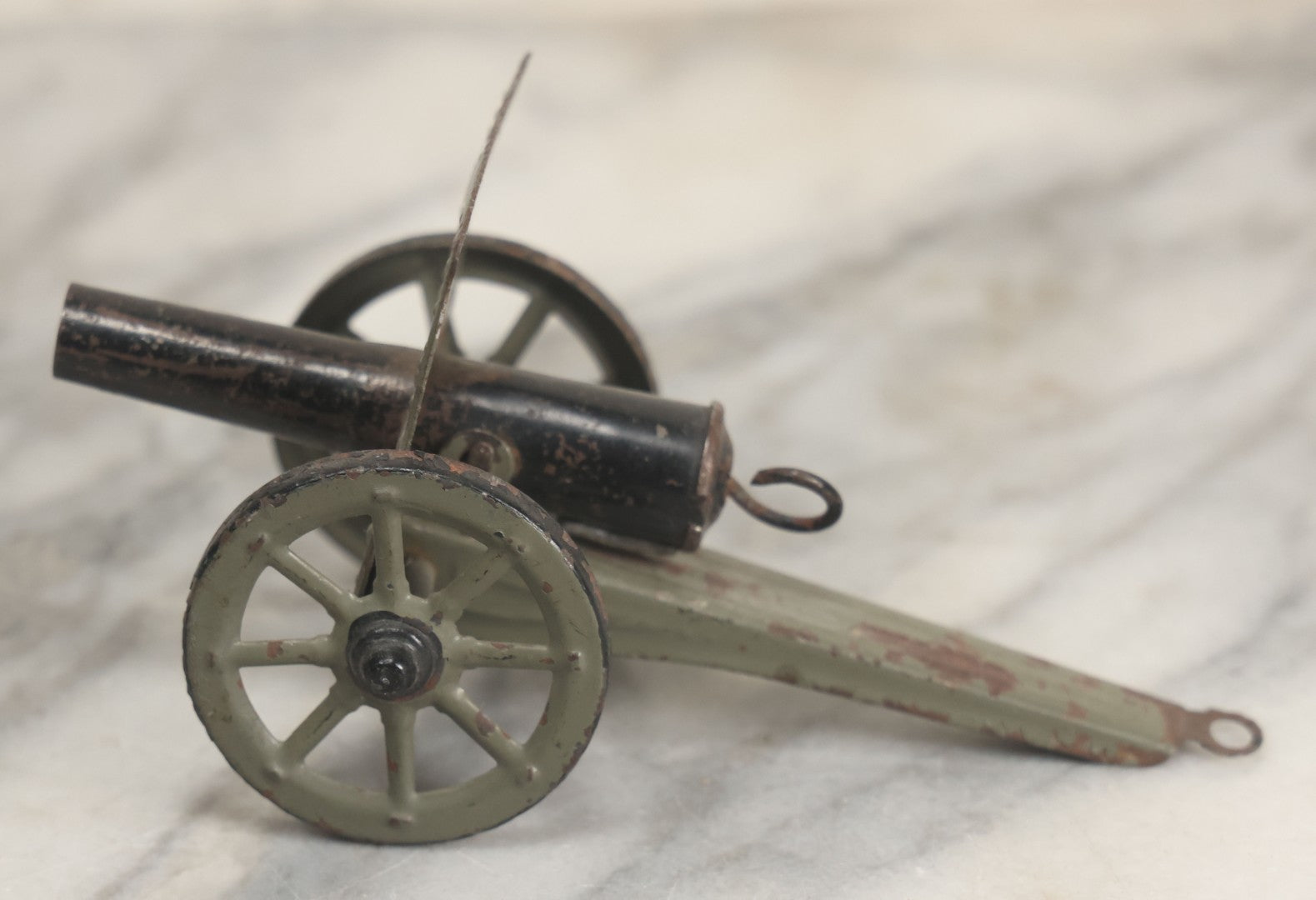 Lot 135 - Vintage Green And Black Painted Tin Toy Cannon With Wheels 