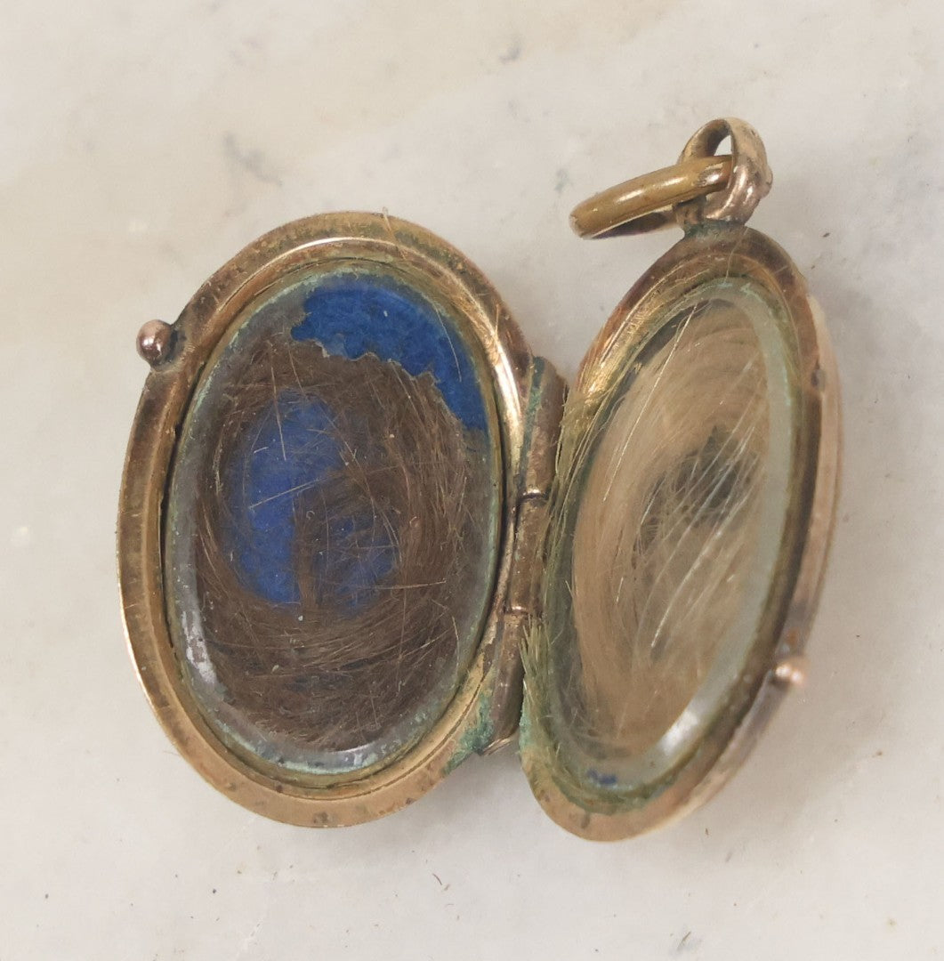 Lot 007 - Antique Victorian Gold Toned Locket With Engraved And Painted Daisies And Blond And Brown Hair Mementos Inside Behind Beveled Glass Windows