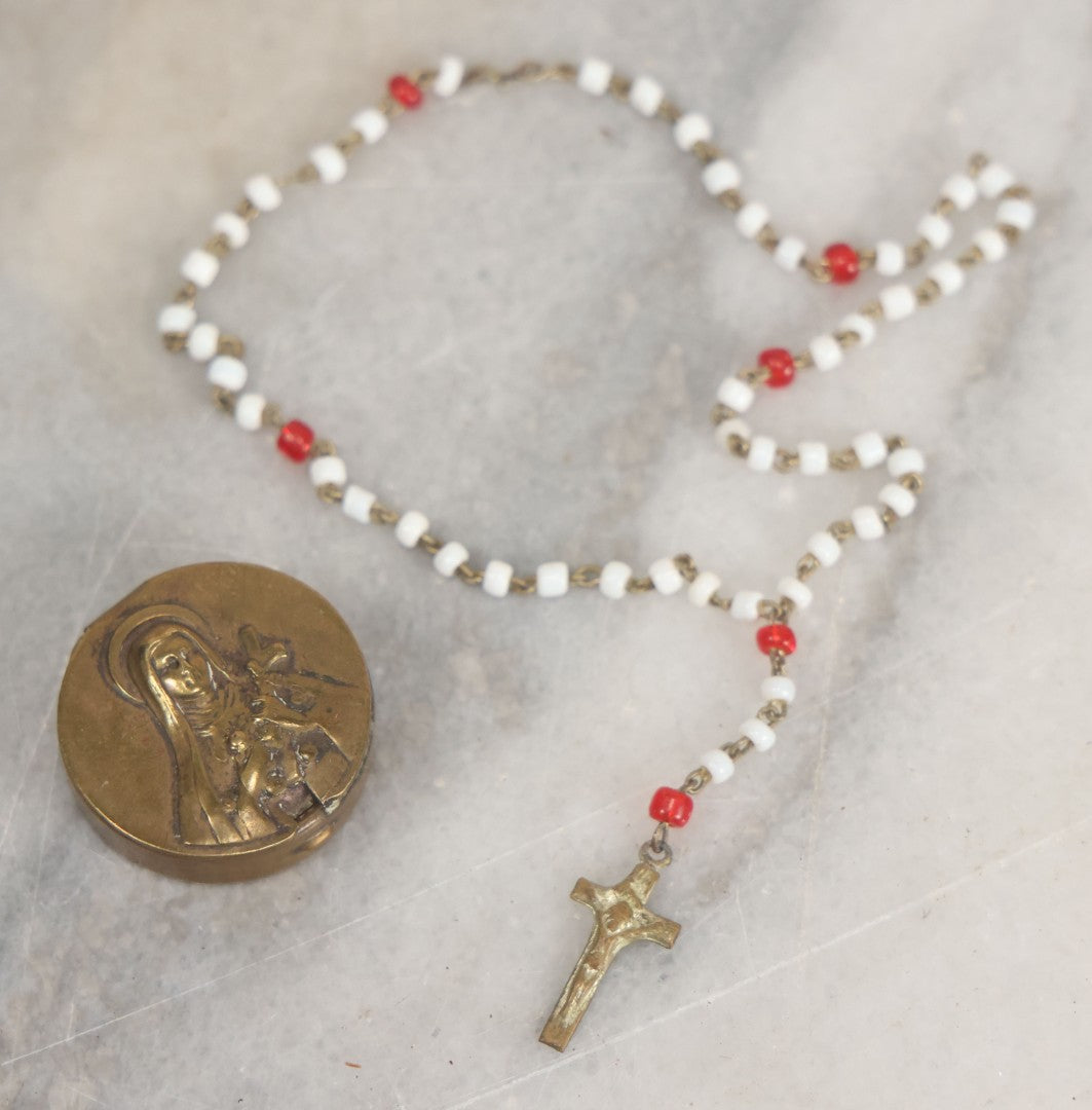 Lot 016 - Vintage Miniature White And Red Glass Rosary Beads With Crucifix In Button Sized Metal Carrying Case With Embossed Saint Therese