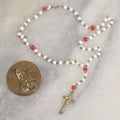 Lot 016 - Vintage Miniature White And Red Glass Rosary Beads With Crucifix In Button Sized Metal Carrying Case With Embossed Saint Therese