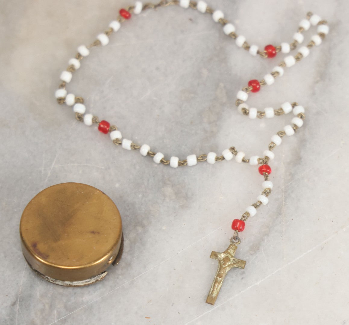 Lot 016 - Vintage Miniature White And Red Glass Rosary Beads With Crucifix In Button Sized Metal Carrying Case With Embossed Saint Therese