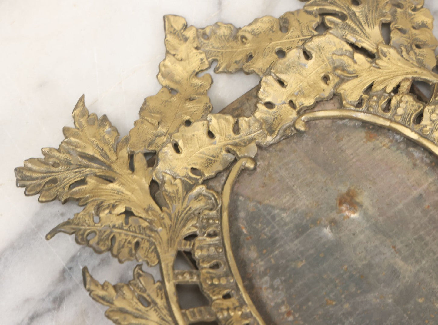 Lot 023 - Antique Ornate Brass Toned Metal Cabinet Card Sized Photo Frame With Leaf Motif, Kickstand, Note Small Losses, Soft Metal