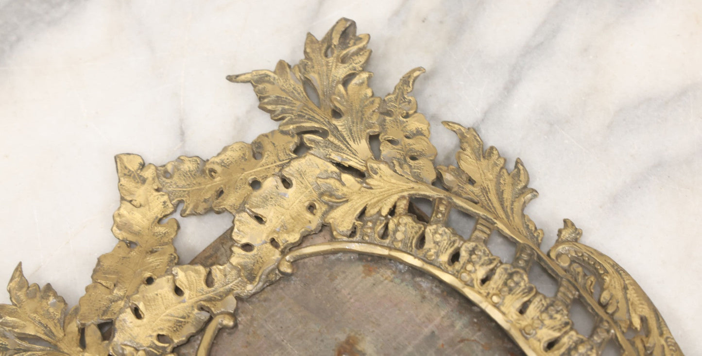 Lot 023 - Antique Ornate Brass Toned Metal Cabinet Card Sized Photo Frame With Leaf Motif, Kickstand, Note Small Losses, Soft Metal