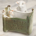 Lot 027 - Antique Porcelain Novelty Vessel With Mama Pig And Pig In Cradle, "Hush Hushabye Baby, Don't You Cry, You'll Be A Sausage Bye And Bye," Stamped Germany, With Remnants Of Original Paint, Note Cracks And Repairs