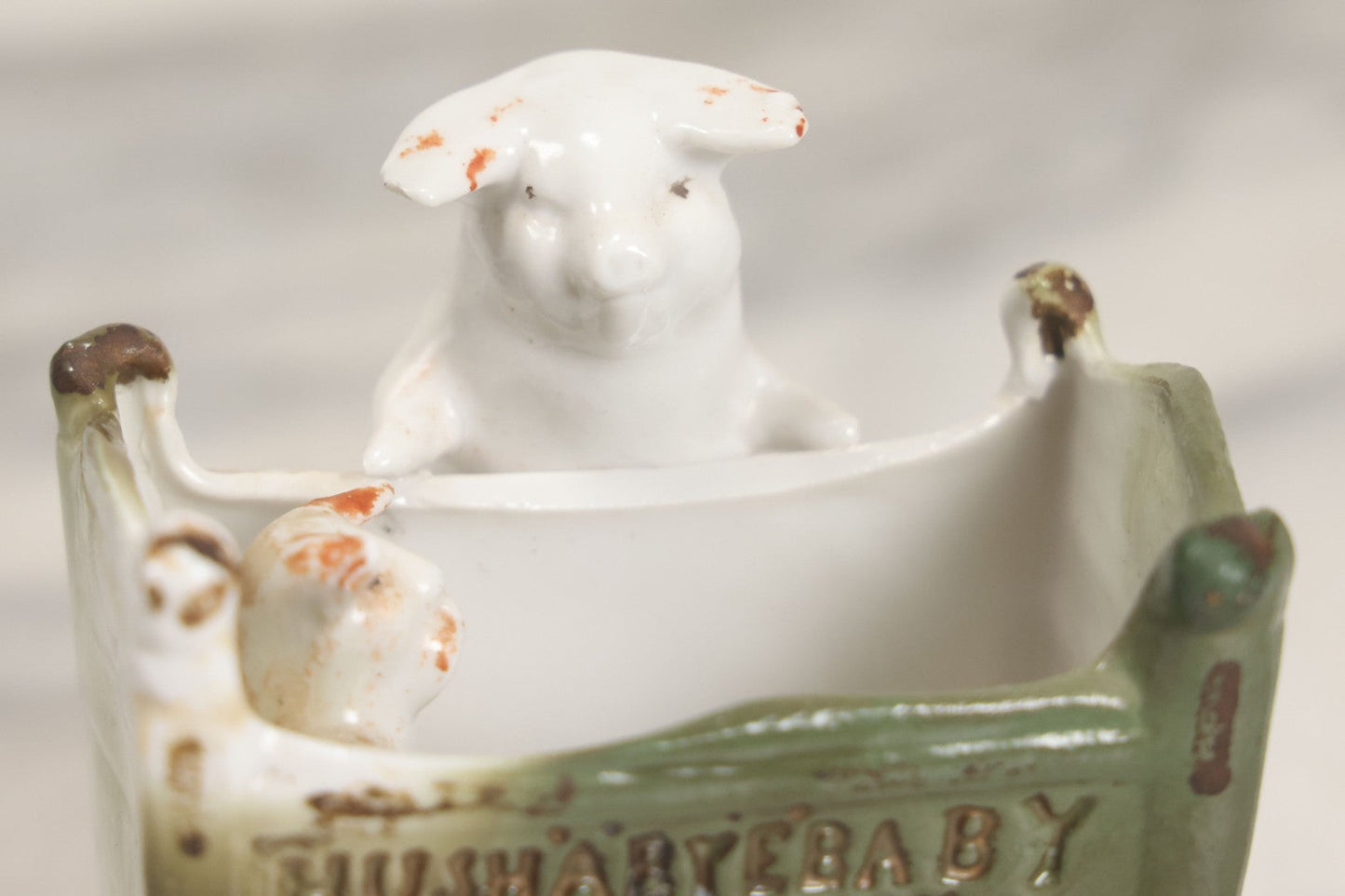 Lot 027 - Antique Porcelain Novelty Vessel With Mama Pig And Pig In Cradle, "Hush Hushabye Baby, Don't You Cry, You'll Be A Sausage Bye And Bye," Stamped Germany, With Remnants Of Original Paint, Note Cracks And Repairs