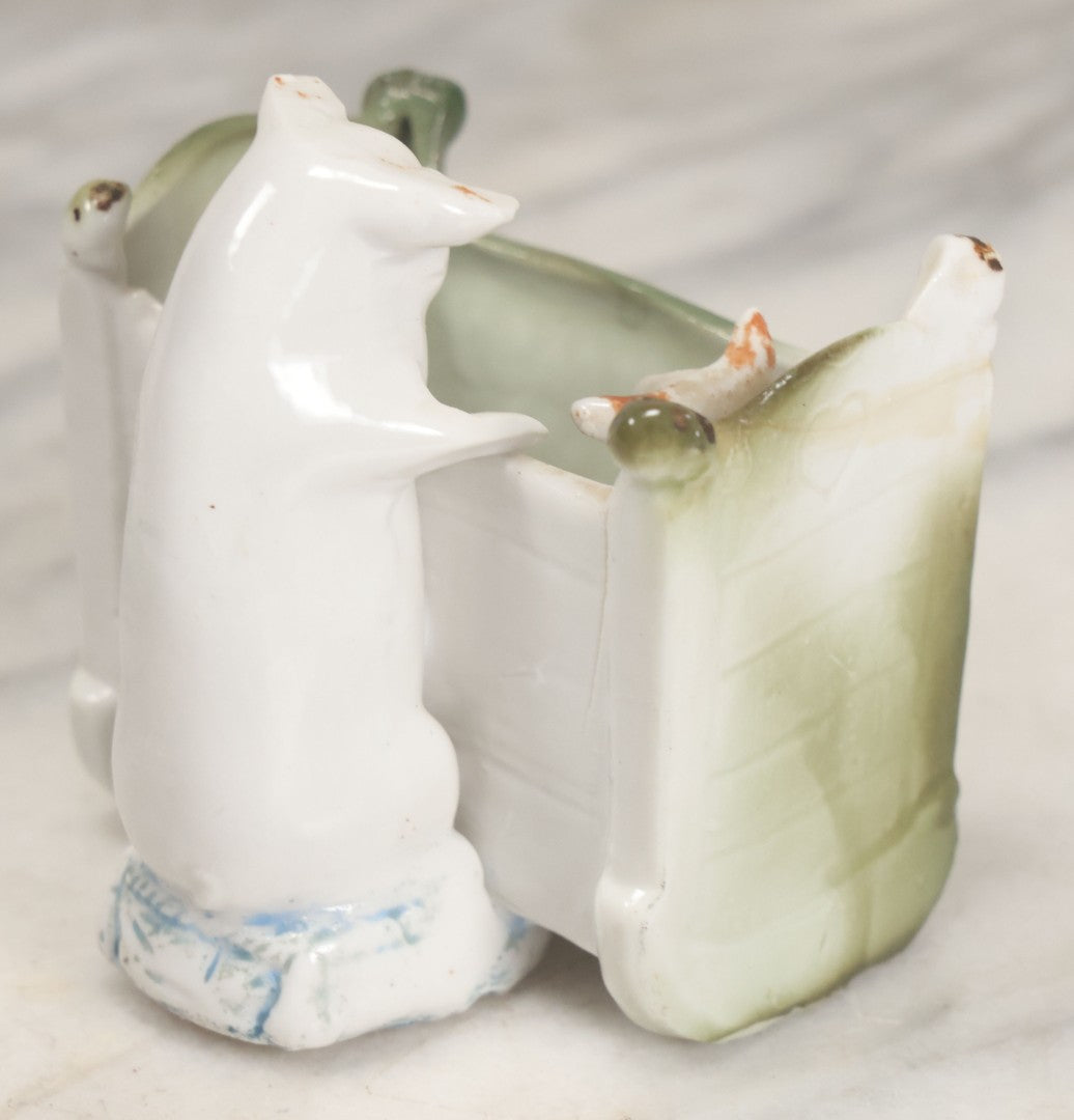 Lot 027 - Antique Porcelain Novelty Vessel With Mama Pig And Pig In Cradle, "Hush Hushabye Baby, Don't You Cry, You'll Be A Sausage Bye And Bye," Stamped Germany, With Remnants Of Original Paint, Note Cracks And Repairs