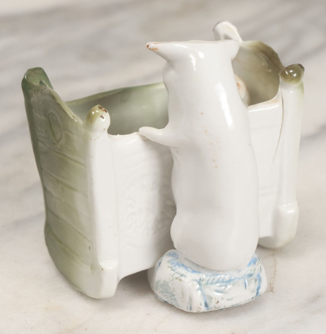 Lot 027 - Antique Porcelain Novelty Vessel With Mama Pig And Pig In Cradle, "Hush Hushabye Baby, Don't You Cry, You'll Be A Sausage Bye And Bye," Stamped Germany, With Remnants Of Original Paint, Note Cracks And Repairs
