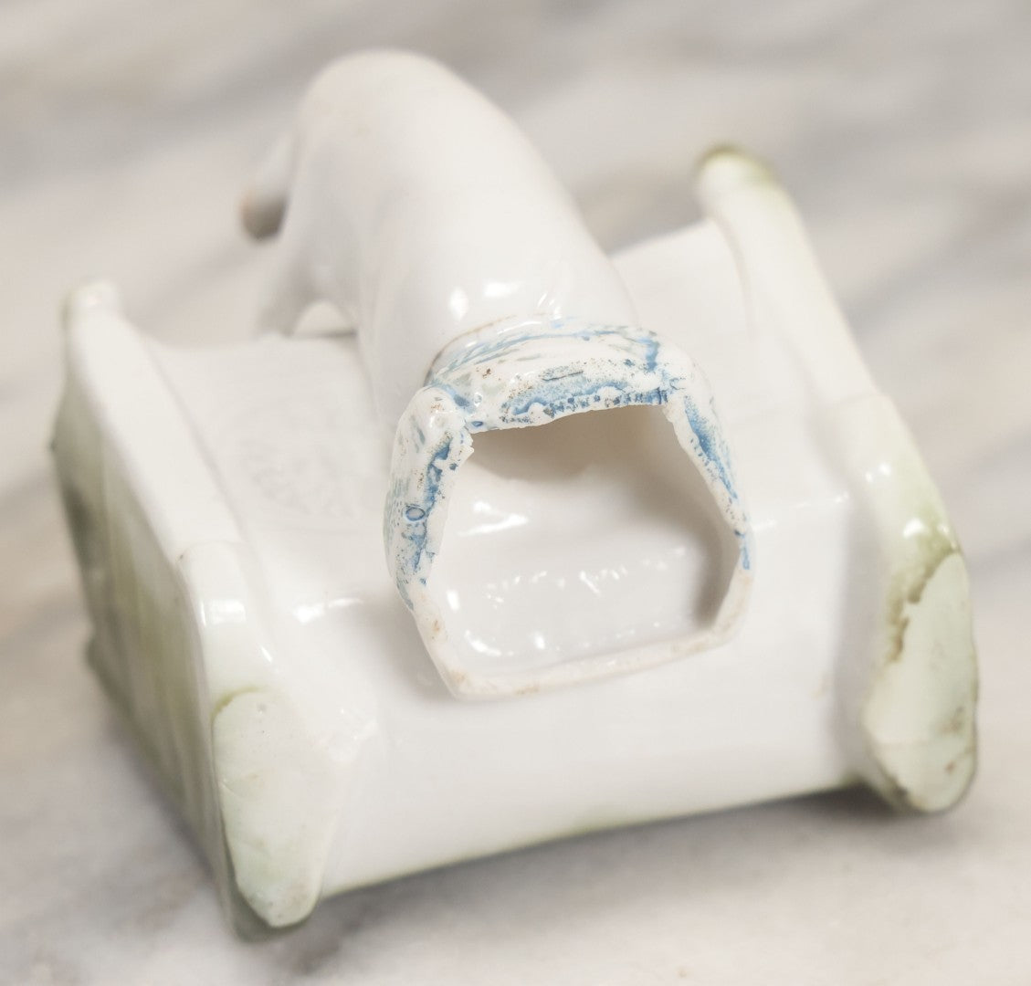 Lot 027 - Antique Porcelain Novelty Vessel With Mama Pig And Pig In Cradle, "Hush Hushabye Baby, Don't You Cry, You'll Be A Sausage Bye And Bye," Stamped Germany, With Remnants Of Original Paint, Note Cracks And Repairs