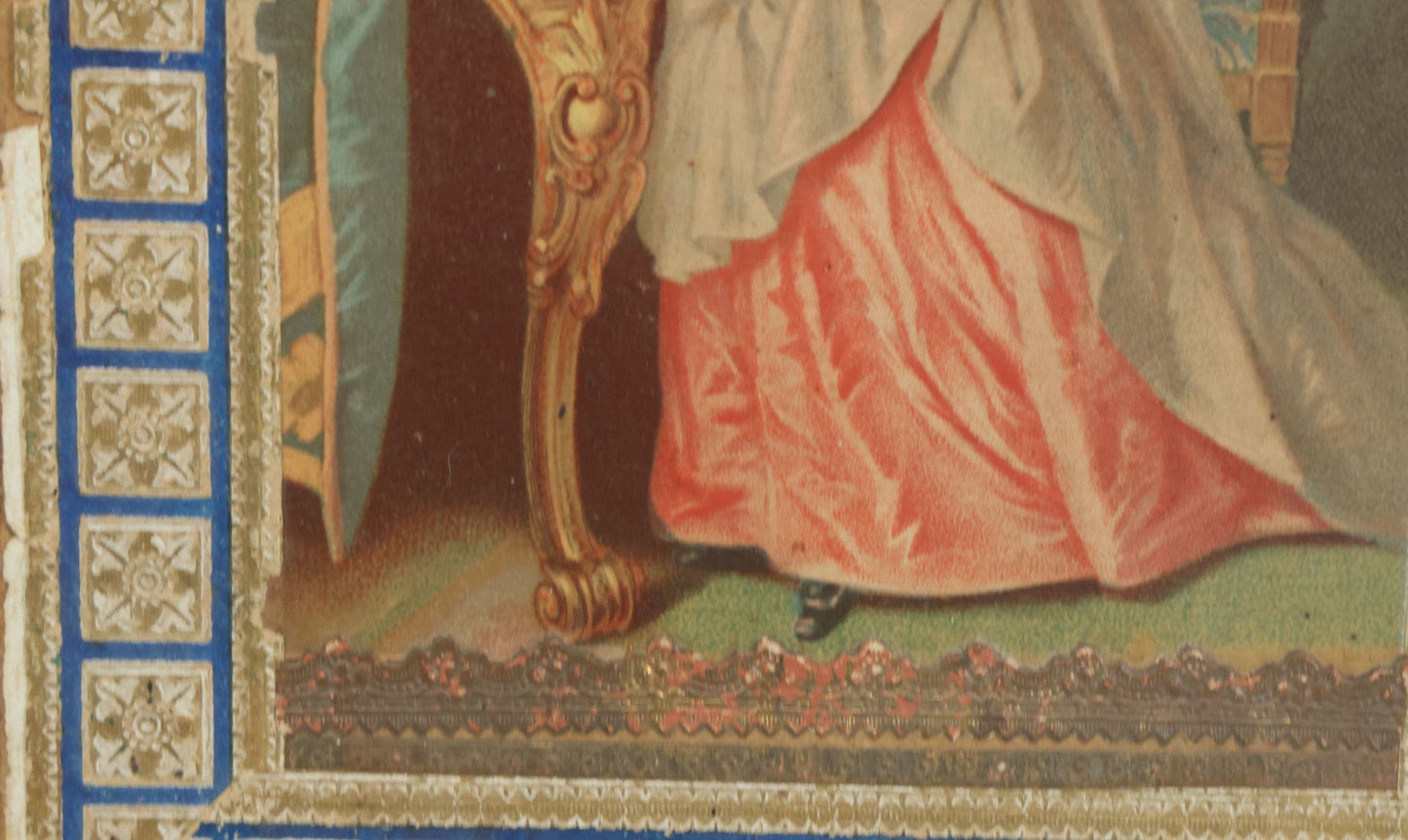 Lot 032 - Antique Lithographed Paper Board Box Cover Depicting Young Woman In Pink Dress Playing With Her Goldfish In Period Etched Wooden Frame, 10-5/8" x 11-3/4"