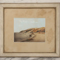 Lot 033 - Antique Painted Over Photograph Of Oceanside Cliffs And Beach With Child Seated On Rocks Likely Gay Head Cliffs, Martha's Vineyard, Massachusetts, In Original Frame, 17-1/2" x 15-1/2"