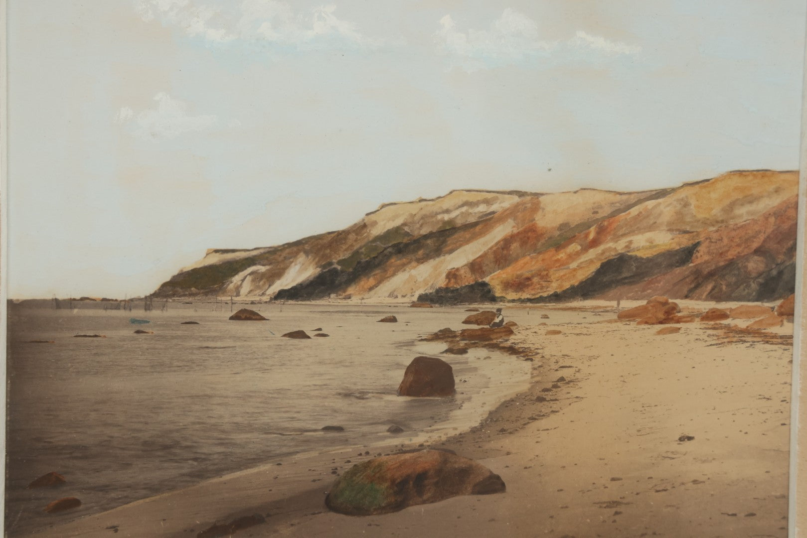 Lot 033 - Antique Painted Over Photograph Of Oceanside Cliffs And Beach With Child Seated On Rocks Likely Gay Head Cliffs, Martha's Vineyard, Massachusetts, In Original Frame, 17-1/2" x 15-1/2"