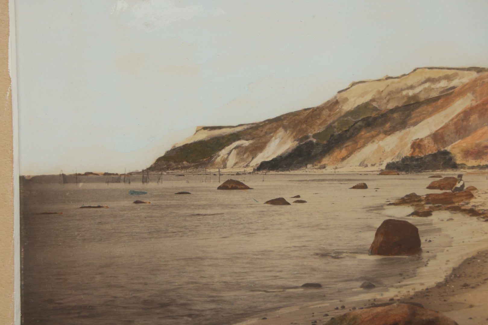 Lot 033 - Antique Painted Over Photograph Of Oceanside Cliffs And Beach With Child Seated On Rocks Likely Gay Head Cliffs, Martha's Vineyard, Massachusetts, In Original Frame, 17-1/2" x 15-1/2"