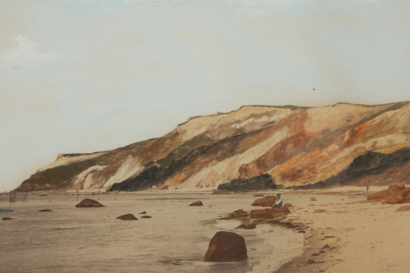 Lot 033 - Antique Painted Over Photograph Of Oceanside Cliffs And Beach With Child Seated On Rocks Likely Gay Head Cliffs, Martha's Vineyard, Massachusetts, In Original Frame, 17-1/2" x 15-1/2"