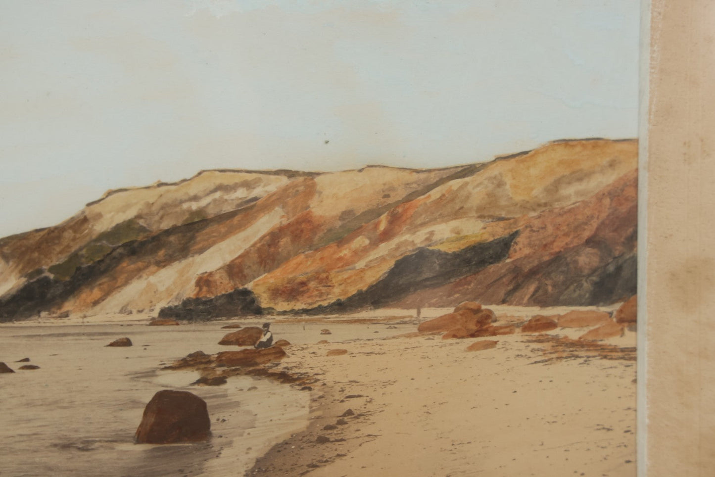 Lot 033 - Antique Painted Over Photograph Of Oceanside Cliffs And Beach With Child Seated On Rocks Likely Gay Head Cliffs, Martha's Vineyard, Massachusetts, In Original Frame, 17-1/2" x 15-1/2"