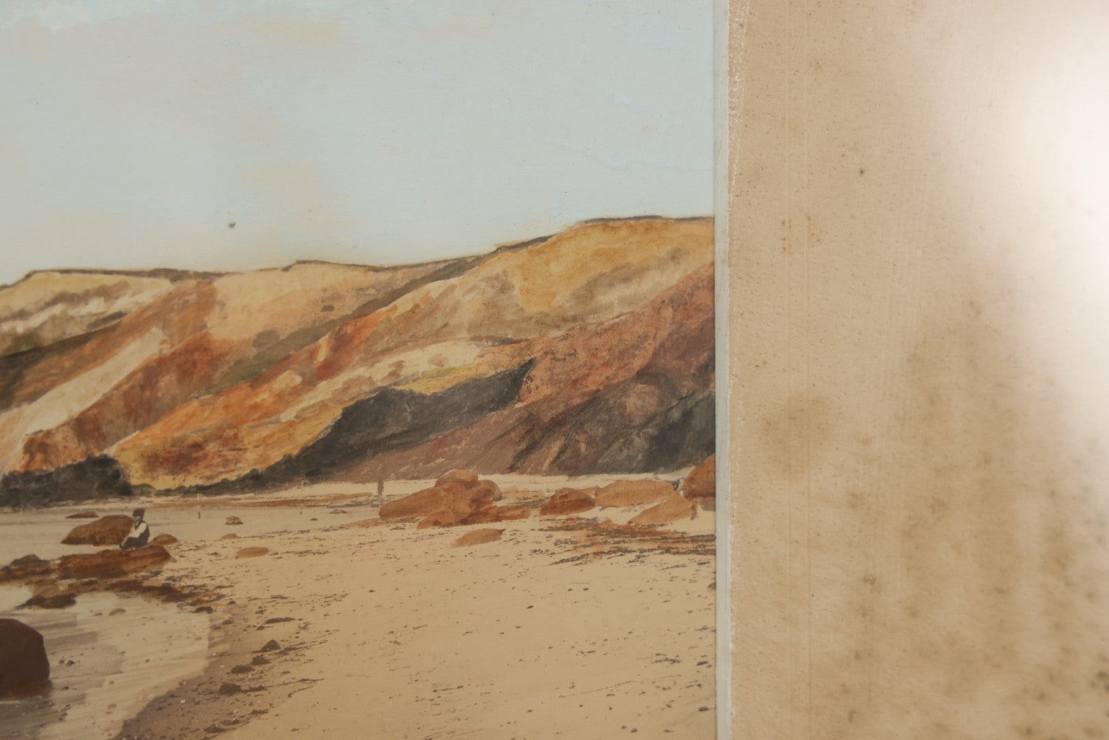Lot 033 - Antique Painted Over Photograph Of Oceanside Cliffs And Beach With Child Seated On Rocks Likely Gay Head Cliffs, Martha's Vineyard, Massachusetts, In Original Frame, 17-1/2" x 15-1/2"