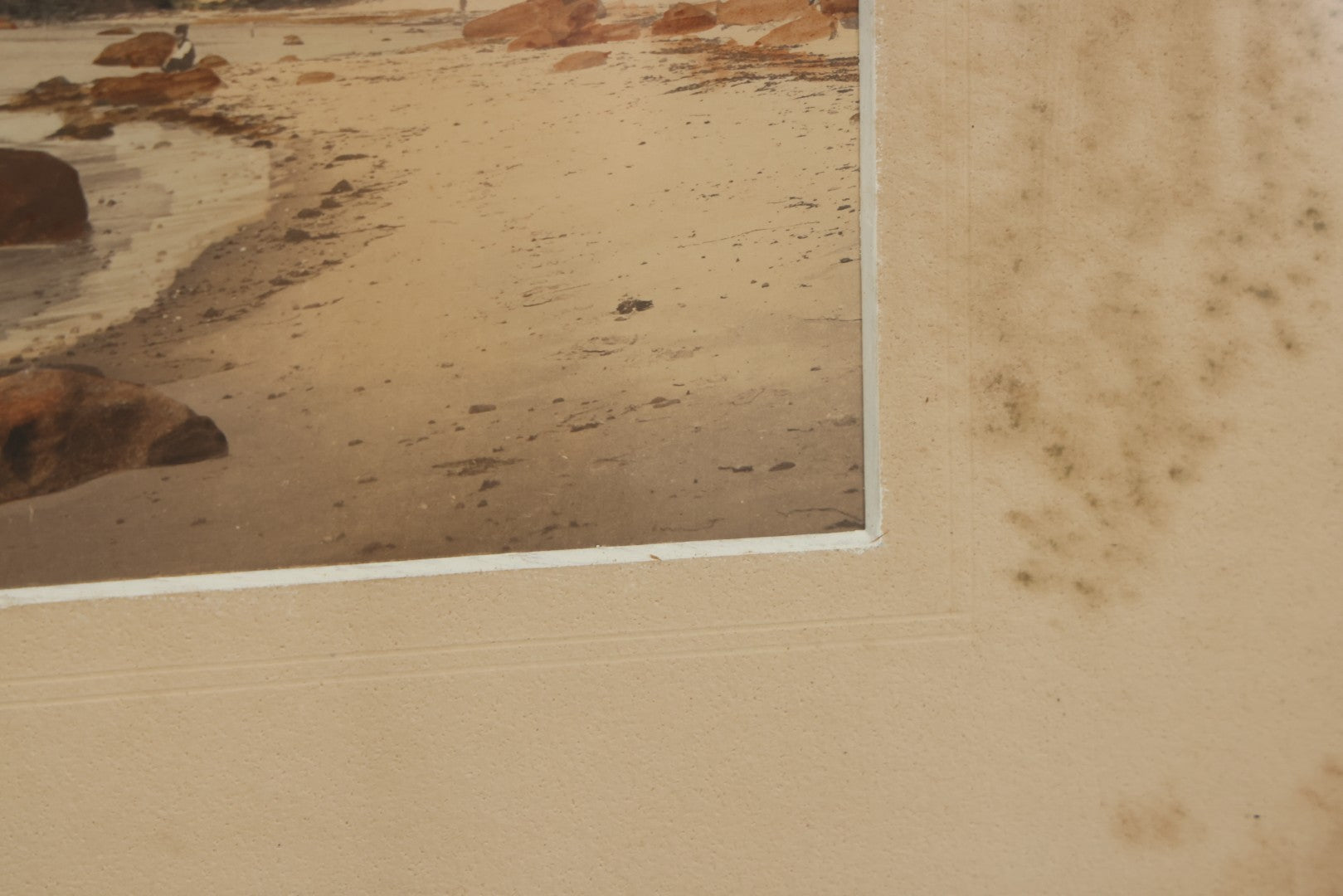 Lot 033 - Antique Painted Over Photograph Of Oceanside Cliffs And Beach With Child Seated On Rocks Likely Gay Head Cliffs, Martha's Vineyard, Massachusetts, In Original Frame, 17-1/2" x 15-1/2"