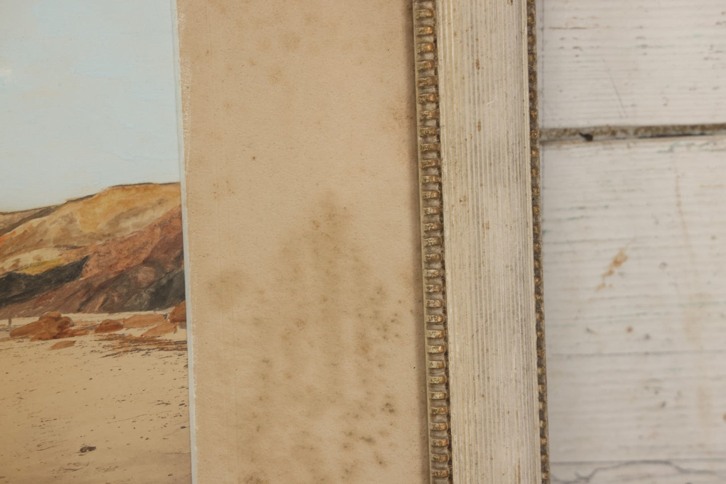 Lot 033 - Antique Painted Over Photograph Of Oceanside Cliffs And Beach With Child Seated On Rocks Likely Gay Head Cliffs, Martha's Vineyard, Massachusetts, In Original Frame, 17-1/2" x 15-1/2"