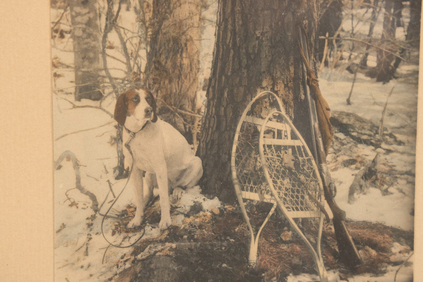Lot 034 - Antique Hand Tinted Hunting Photograph With Hunting Dog Snowshoes And Rifle, Signed In Pencil Lower Left Homes "The Studio," Chocorua, New Hampshire, In Original Frame, 12-1/2" x 14-1/2"
