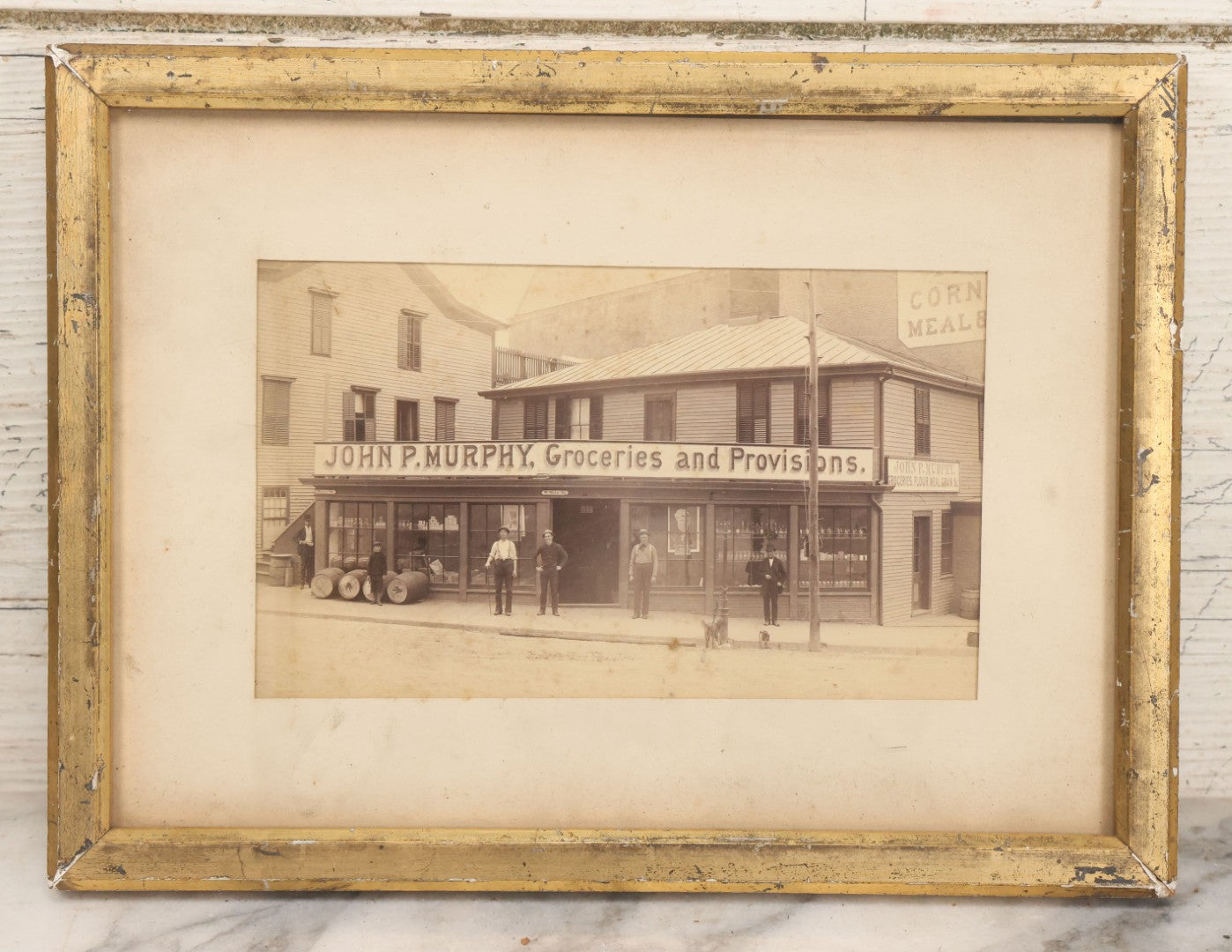 Lot 035 - Antique Occupational Photograph Depicting The Proprietors And Workers Of John P. Murphy Groceries And Provisions General Store, Located On West Main Street, Unknown City, Dog Visible In Photograph, In Period Frame, As Found, 11-1/2" x 8-1/2"