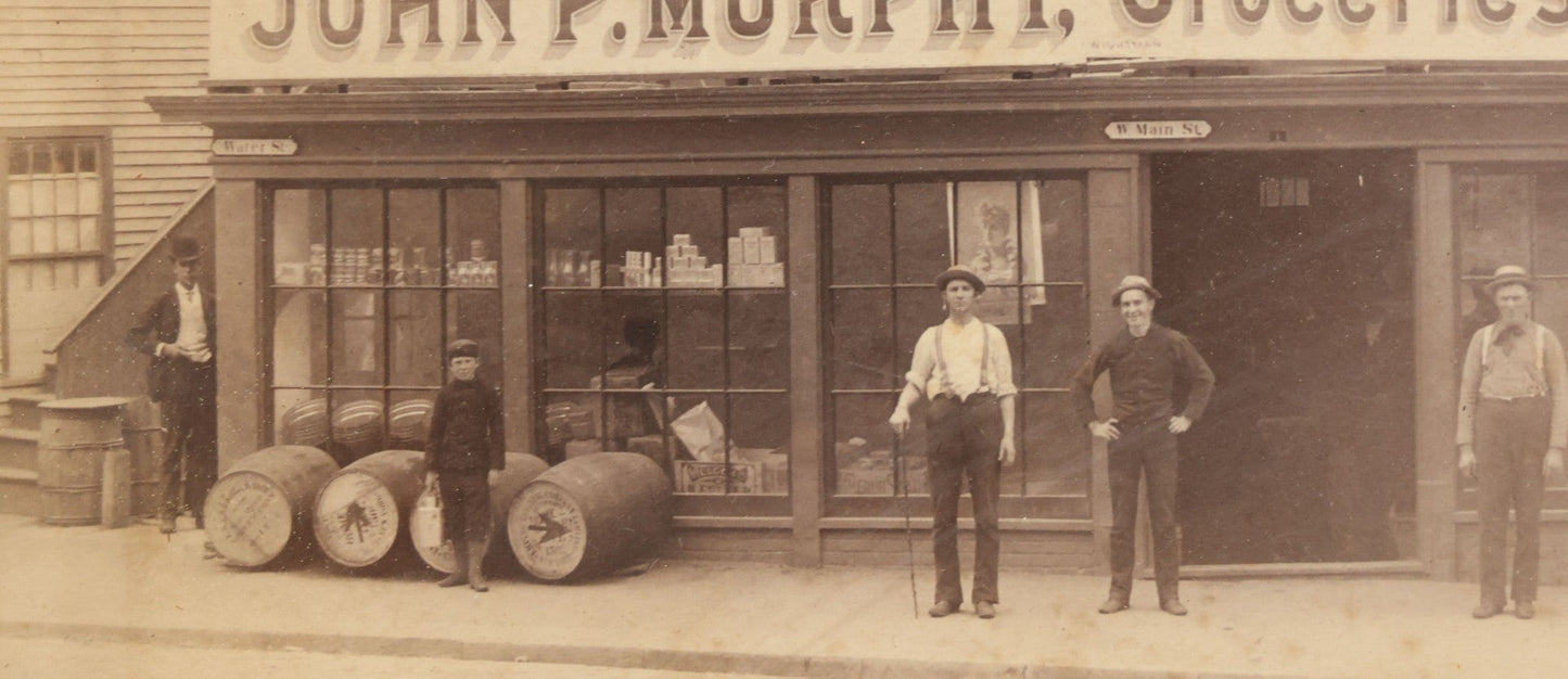 Lot 035 - Antique Occupational Photograph Depicting The Proprietors And Workers Of John P. Murphy Groceries And Provisions General Store, Located On West Main Street, Unknown City, Dog Visible In Photograph, In Period Frame, As Found, 11-1/2" x 8-1/2"