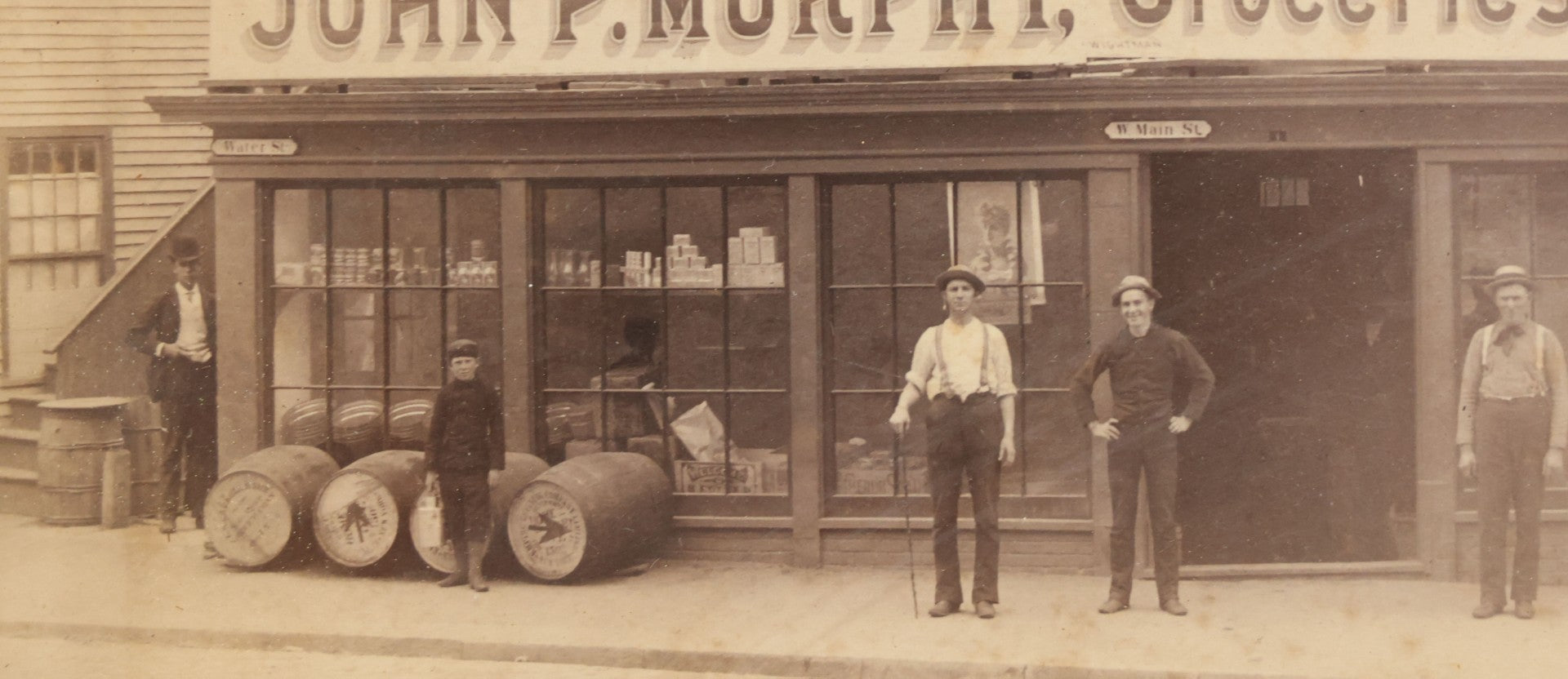 Lot 035 - Antique Occupational Photograph Depicting The Proprietors And Workers Of John P. Murphy Groceries And Provisions General Store, Located On West Main Street, Unknown City, Dog Visible In Photograph, In Period Frame, As Found, 11-1/2" x 8-1/2"