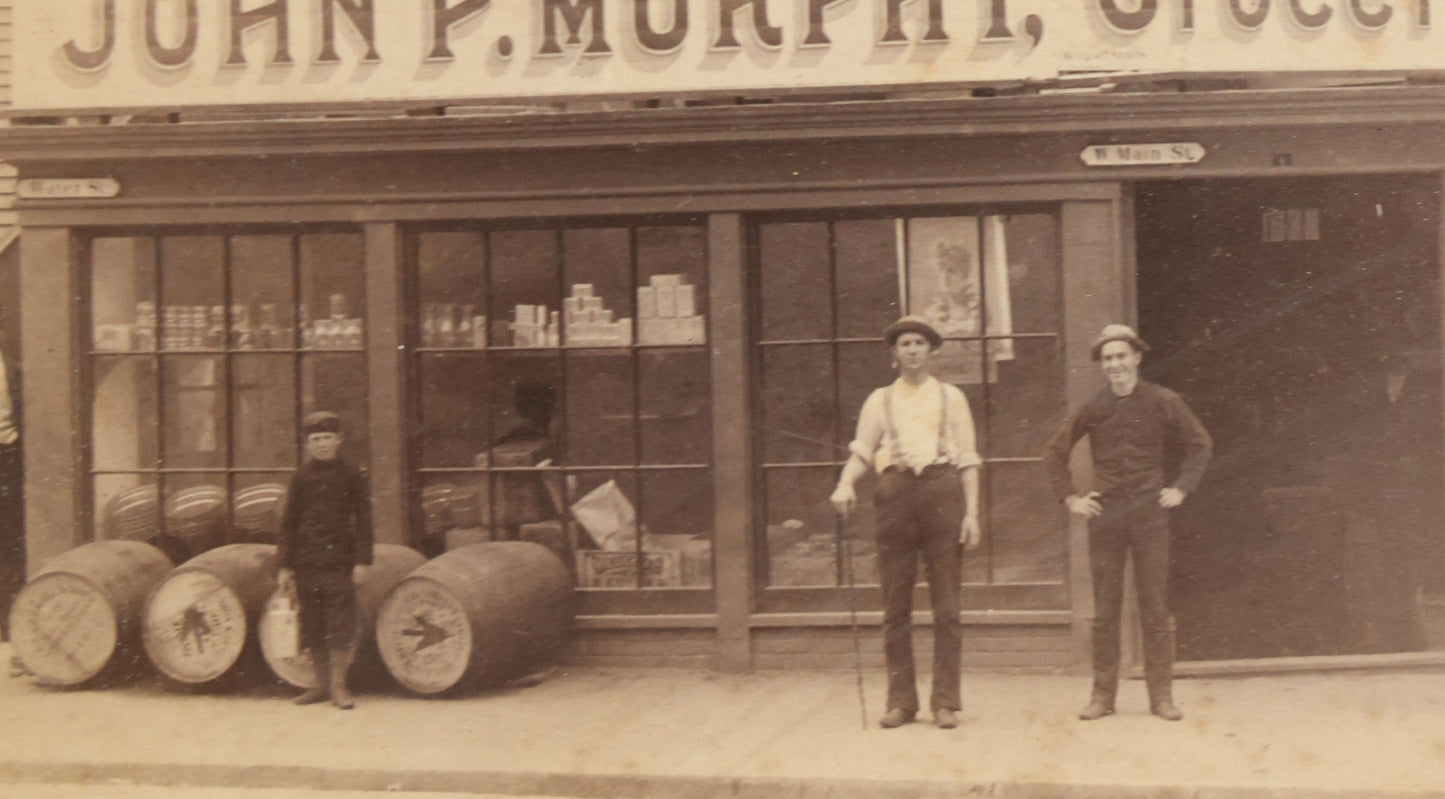 Lot 035 - Antique Occupational Photograph Depicting The Proprietors And Workers Of John P. Murphy Groceries And Provisions General Store, Located On West Main Street, Unknown City, Dog Visible In Photograph, In Period Frame, As Found, 11-1/2" x 8-1/2"