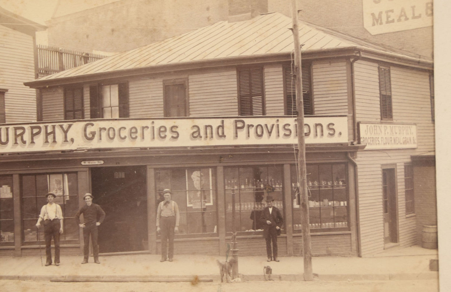 Lot 035 - Antique Occupational Photograph Depicting The Proprietors And Workers Of John P. Murphy Groceries And Provisions General Store, Located On West Main Street, Unknown City, Dog Visible In Photograph, In Period Frame, As Found, 11-1/2" x 8-1/2"